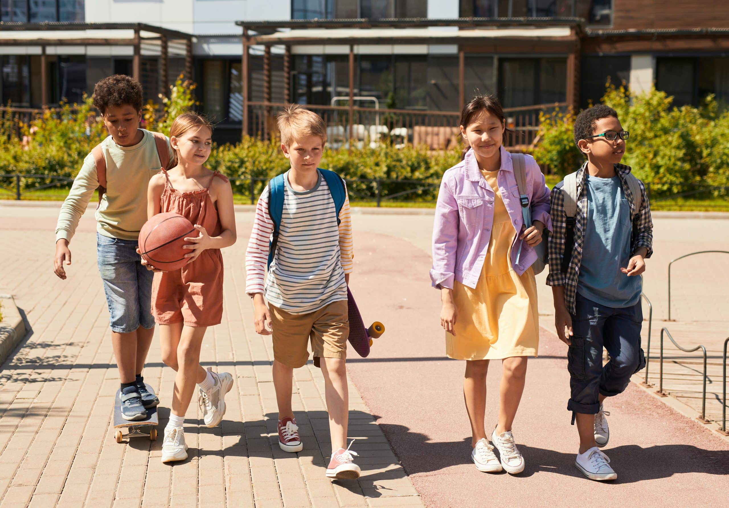 children happily walking into the school grounds